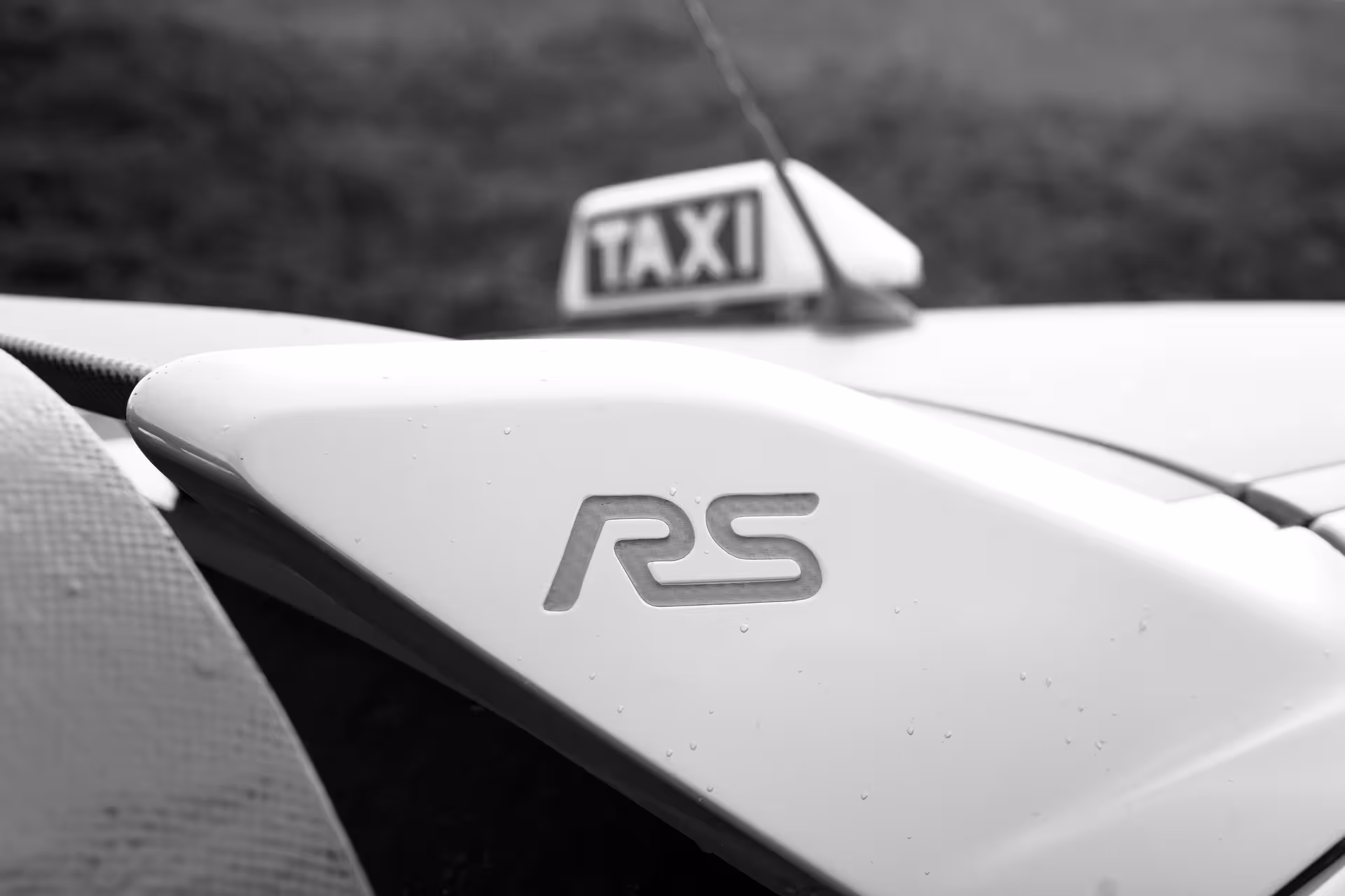 Close-up of RS badge and taxi sign on performance car used for Krýsuvík geothermal sprint experience in Iceland
