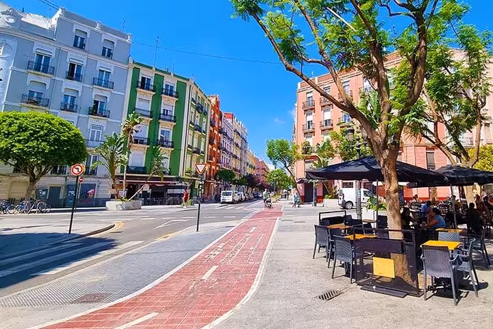 Sunny Ruzafa Valencia street with terraces, starting point for evening tapas, drinks and local secrets tour