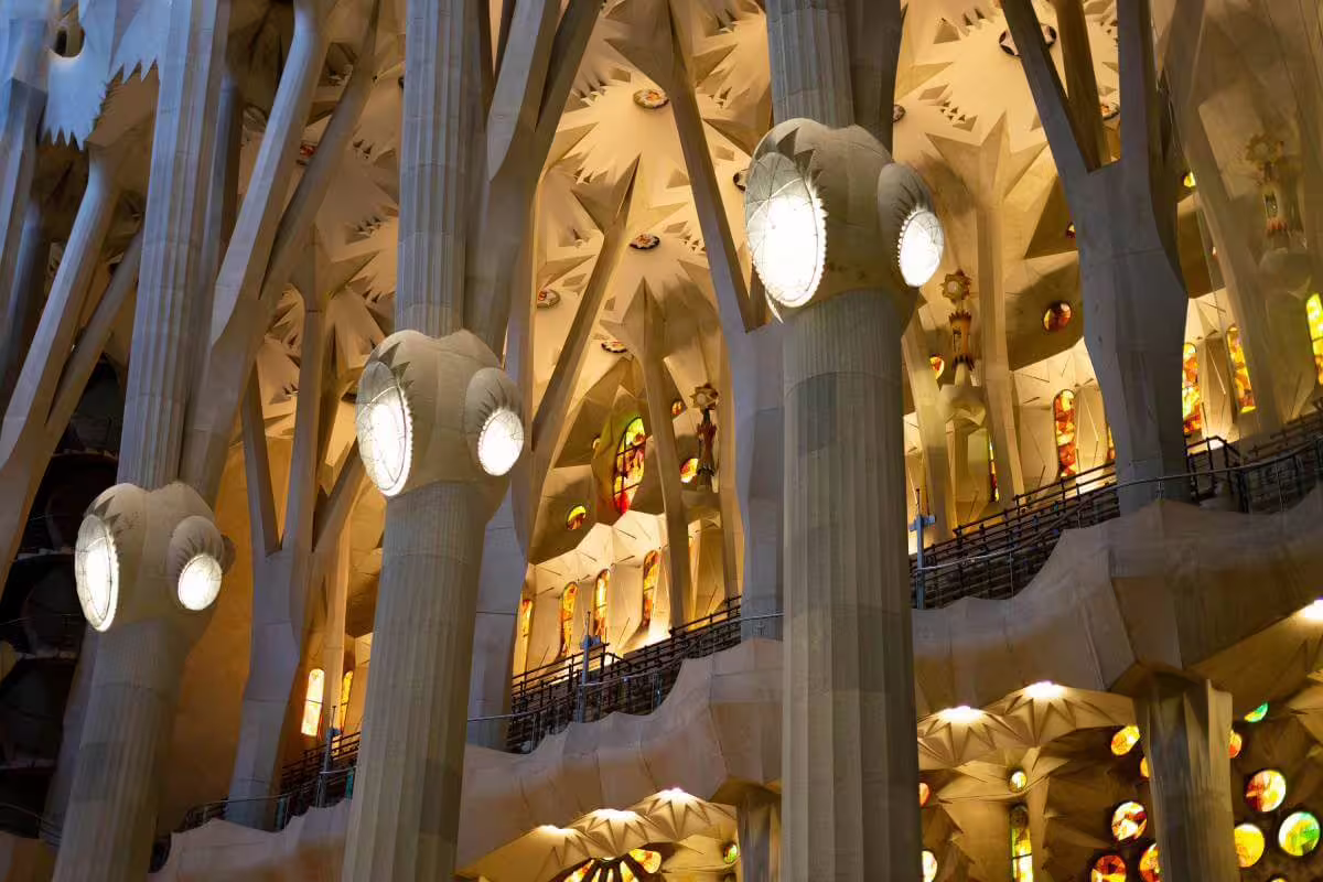 Stunning architectural columns and lighting within Sagrada Familia, highlighting Gaudí's creativity on a skip-the-line guided tour.