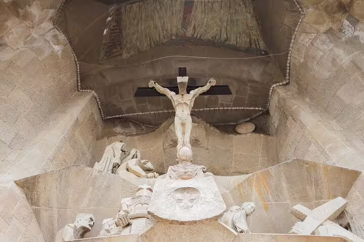 Sculptural depiction of crucifixion on Sagrada Familia, part of the guided tour experience with skip the line entry.