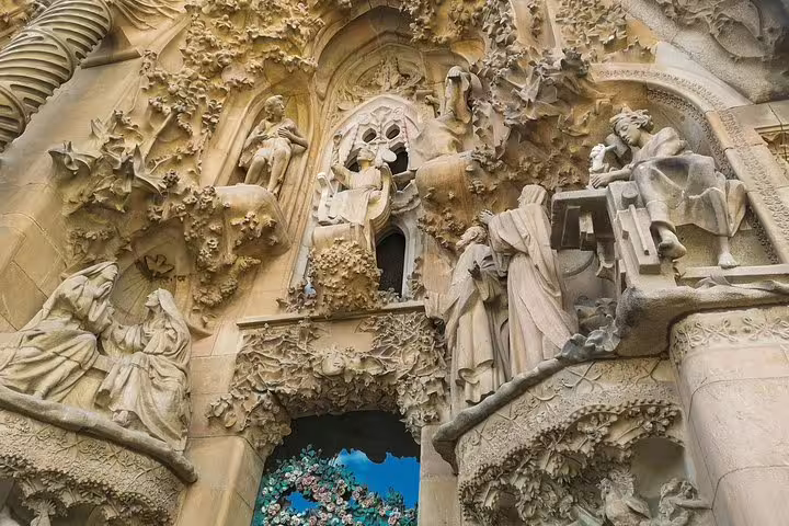 Intricate sculptures on the Sagrada Familia facade, showcasing Gaudi's iconic architectural style on a private tour with skip-the-line tickets.