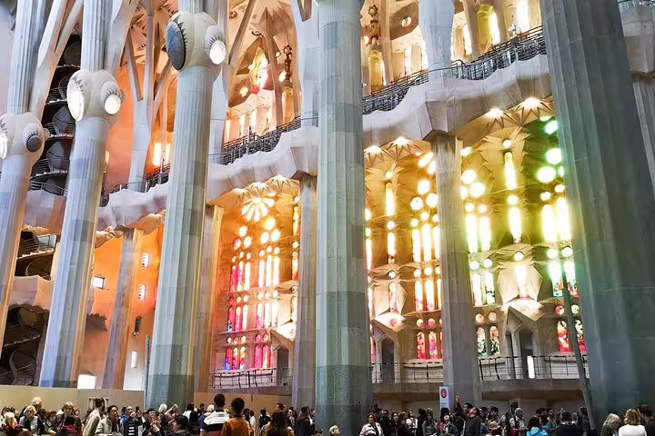 Interior view of Sagrada Familia with vibrant stained glass windows, showcasing Gaudi's architectural brilliance on a private tour.