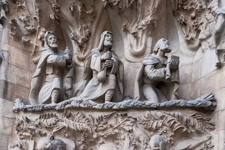 Intricate stone carvings of biblical figures on Sagrada Familia's façade, highlighting the tour’s cultural depth.