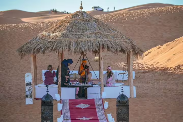 Sahara desert camp lounge with thatched canopy and tea, highlight of Morocco Anti-Atlas & Sahara 8-day tour