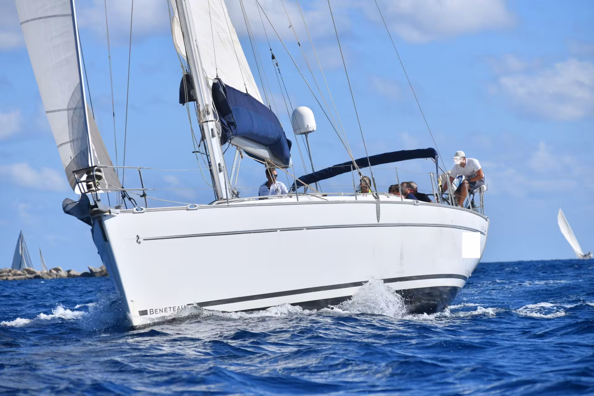 Sailing boat gliding through the blue waters of the Gulf of Orosei under a clear sky.