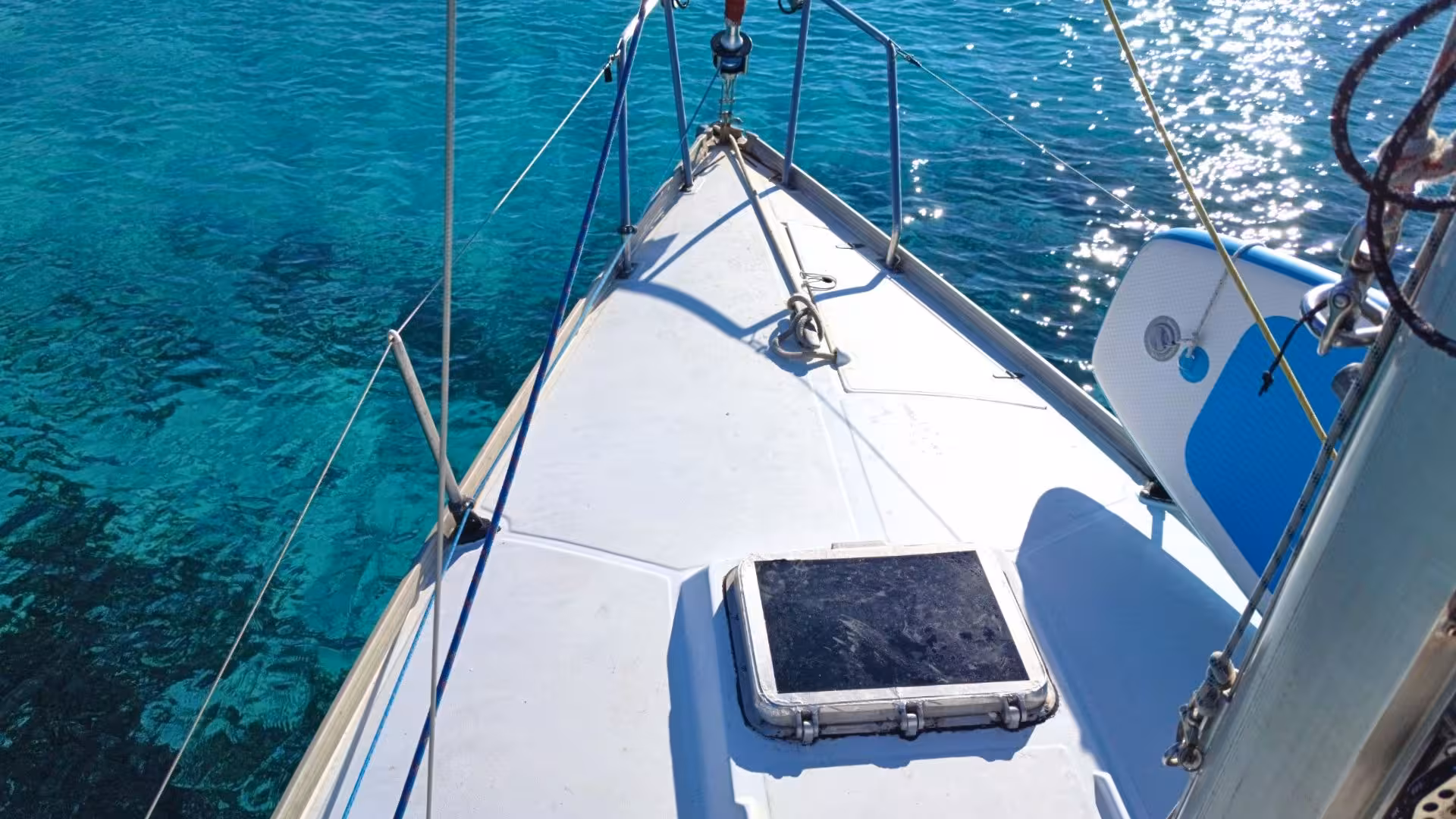 View from a sailboat deck on clear blue waters during a scenic tour from Santa Teresa di Gallura to southern Corsica.