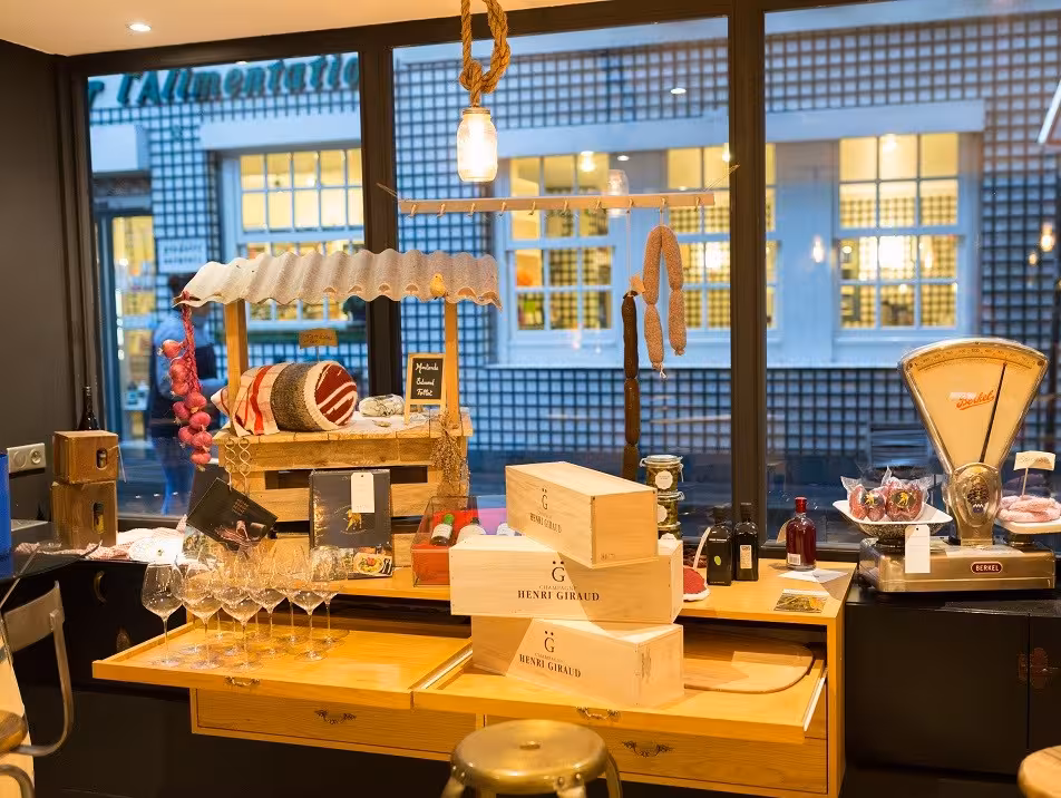 Elegant Parisian deli showcasing fine wines, artisanal cheeses, and gourmet charcuterie in Saint-Germain.