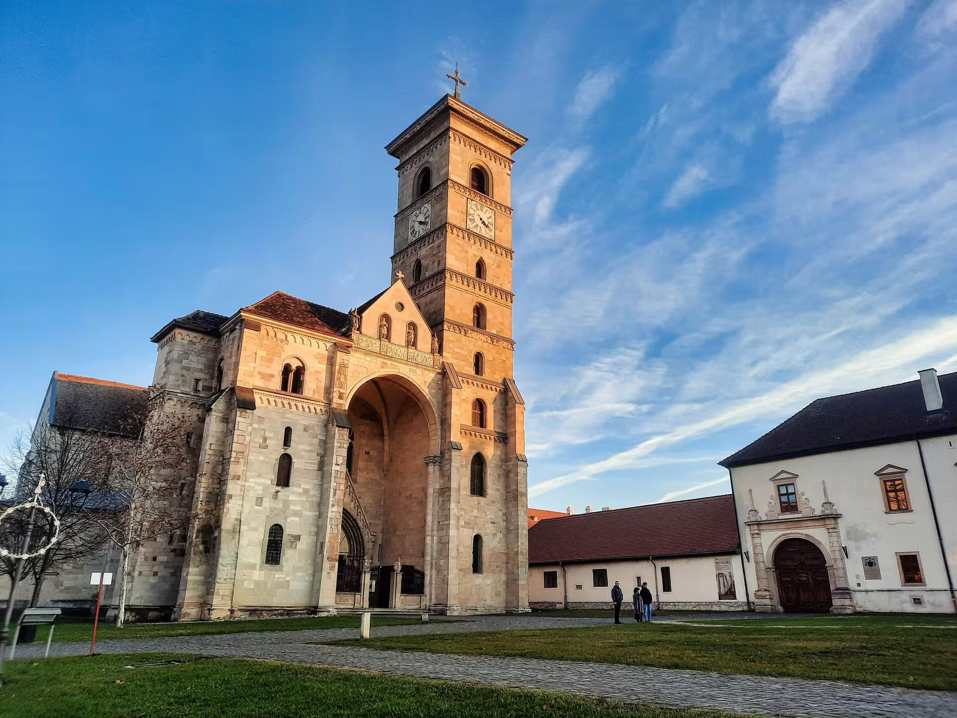 Romanesque Saint Michael Cathedral in Alba Iulia glowing at sunset on a Transylvania guided tour