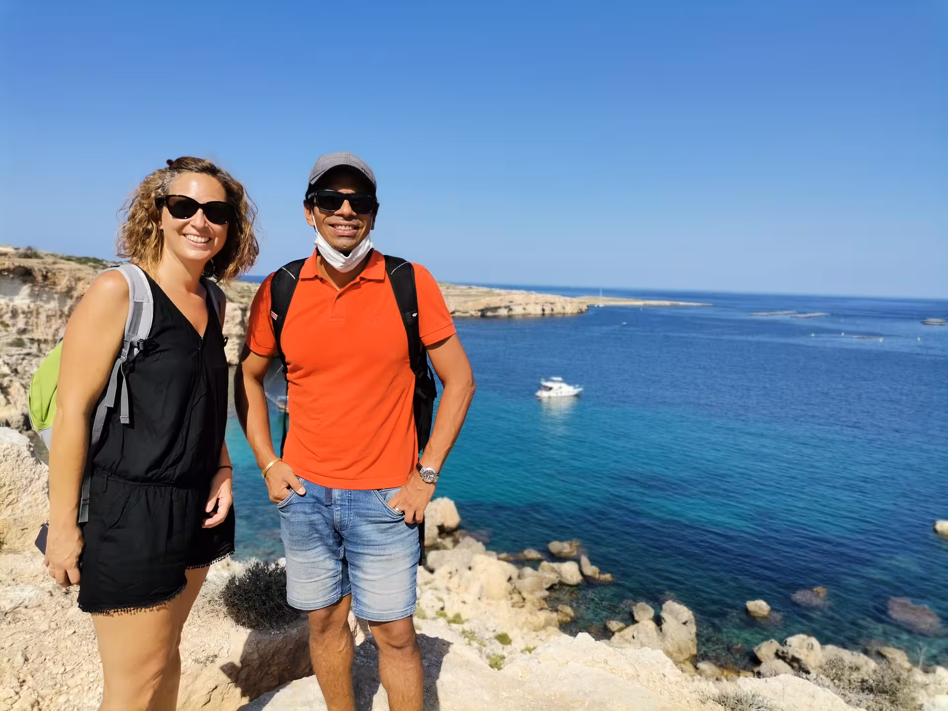 Hikers at a Saint Pauls Bay viewpoint in Malta, guided coastal walk with local picnic and crystal-clear sea views