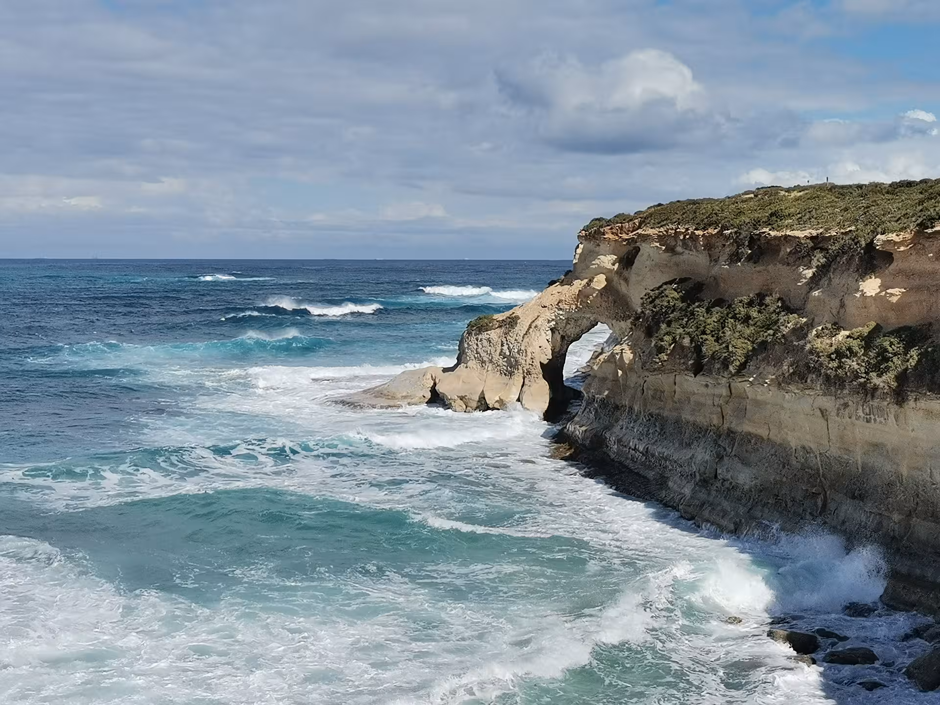 Sea arch and rugged cliffs near Saint Pauls Bay, Malta, on scenic hiking tour with local picnic by the coast