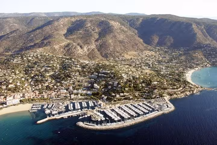 Aerial view of Saint-Tropez marina and coastline, highlight of day trip from Bormes-les-Mimosas