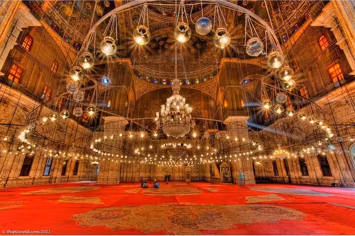 Ornate mosque interior at Salah El-Din Citadel, Cairo tour with chandeliers and red carpet prayer hall