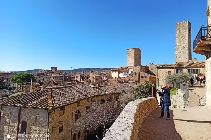 Panoramic view of medieval San Gimignano rooftops and towers on a sunny Chianti private walking tour in Tuscany, Italy