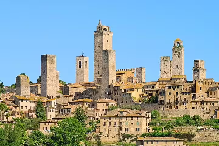 Medieval towers and stone houses of San Gimignano under a clear sky, seen on a private Chianti countryside day trip