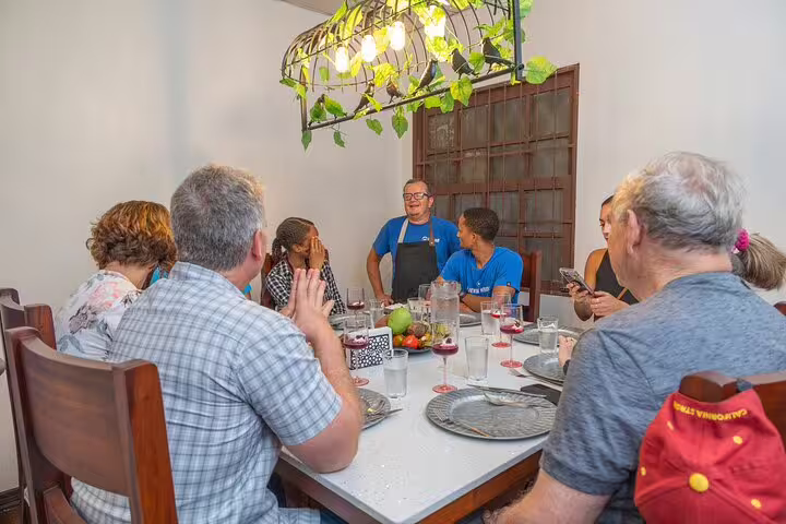 Guests enjoying a lively cocktail class with a chef in a cozy dining area on the San Jose By Night tour.