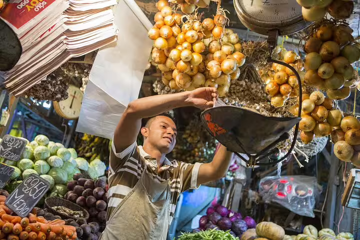 Local vendor at a San Jose market showcasing fresh produce, highlighting farm-to-table ingredients for the night tour.