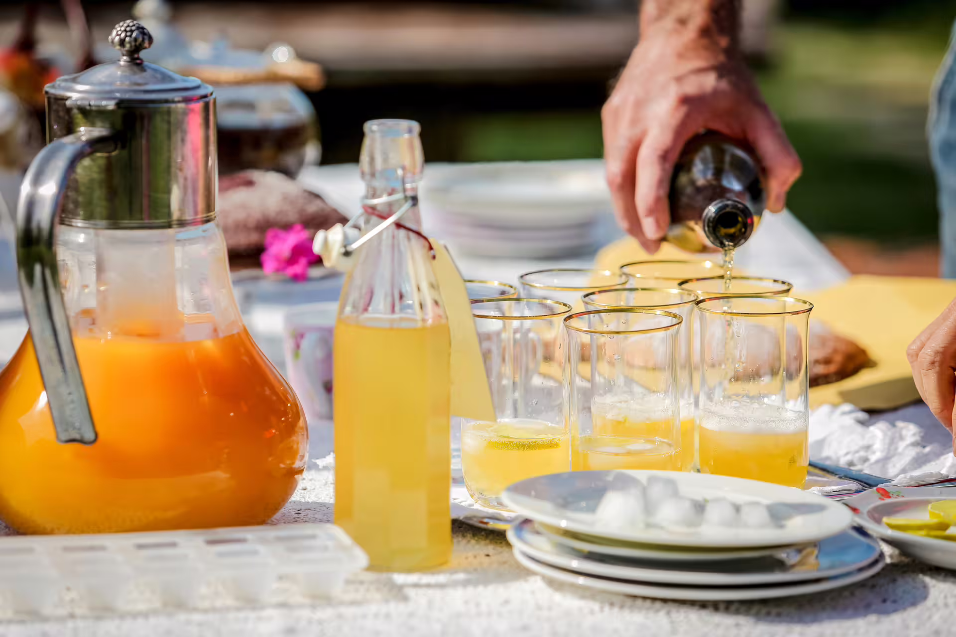Farm aperitivo with local drinks poured into glasses during San Leo Cashmere farm experience in Italy