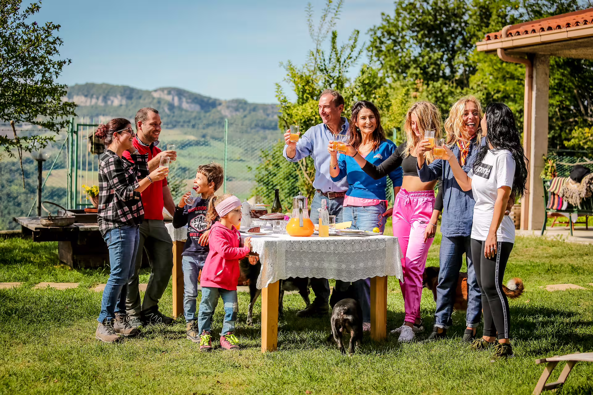 Guests toast outdoors at San Leo Cashmere farm experience, tasting local drinks with mountain views in Italy