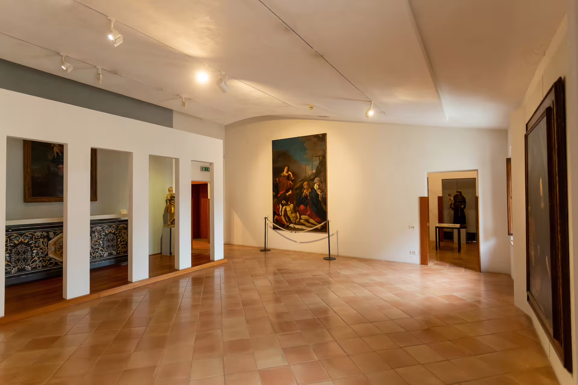 Interior of San Leo Fortress showcasing historic art and sculptures, part of Cagliostro's Prison tour experience.