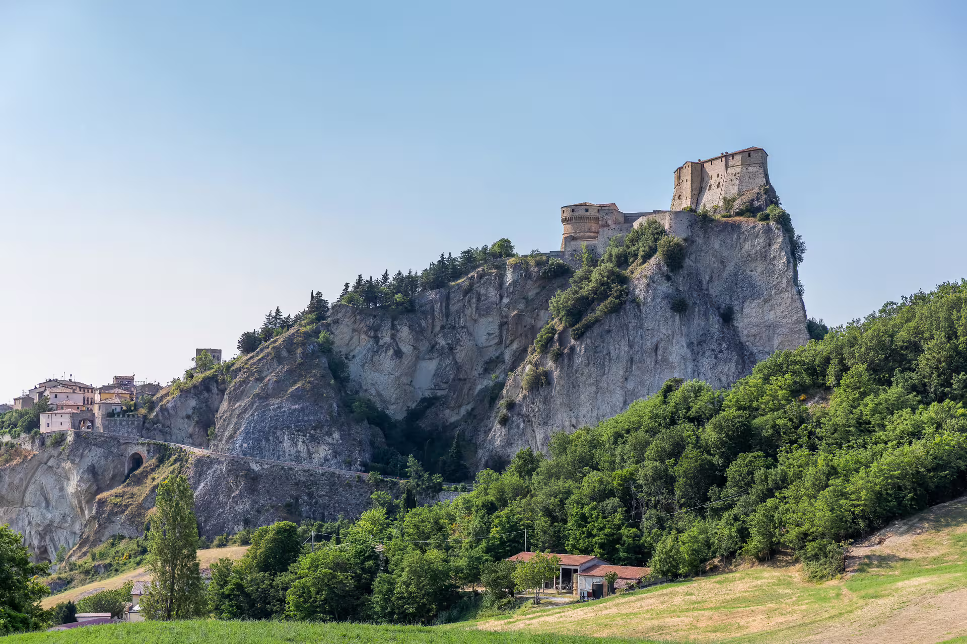San Leo Fortress majestically crowns a rocky cliff, offering breathtaking views of the surrounding landscape and village.