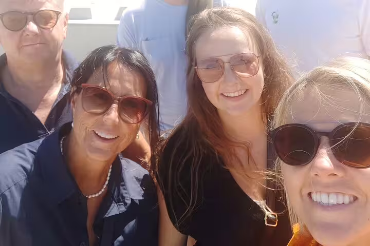 Group selfie on a sunny day in San Sebastián while playing a self-guided e-scavenger hunt walking tour game