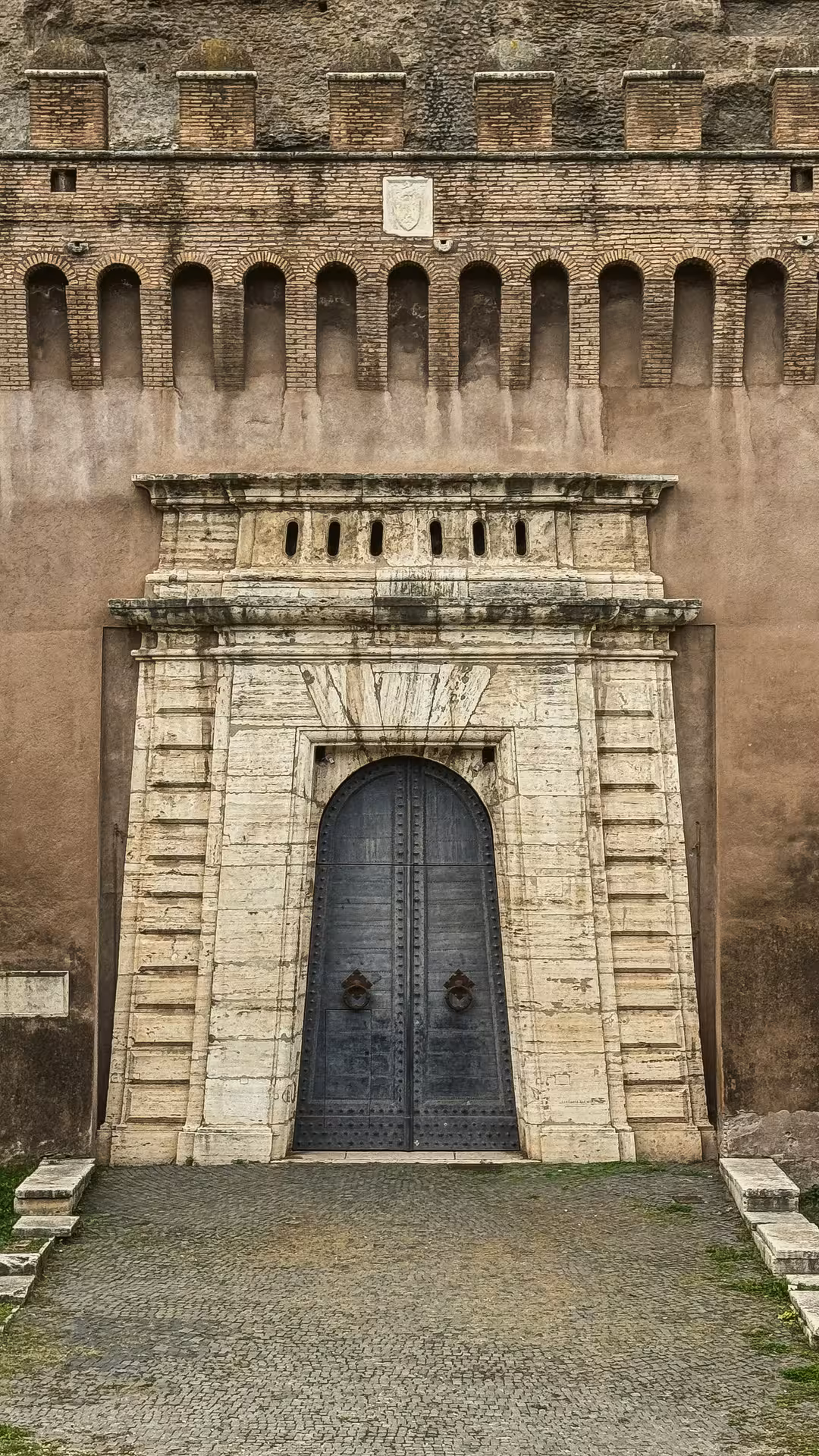 The grand entrance of Sant'Angelo Castle showcases its impressive architectural details and historic charm.