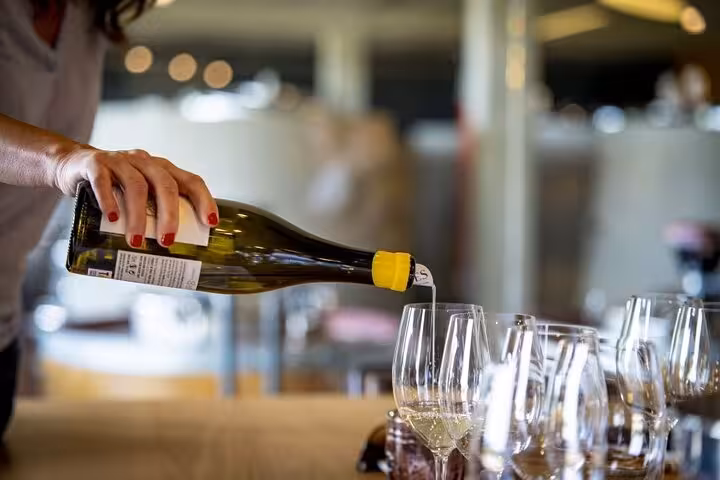 Wine being poured into glasses during a Santiago de Compostela wine tasting experience.