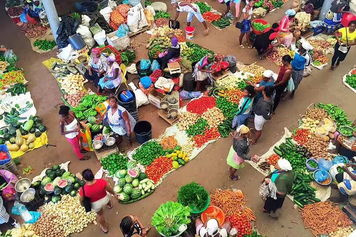 Vibrant local market scene in Santiago Island, showcasing fresh produce and bustling activity for an authentic cultural experience.