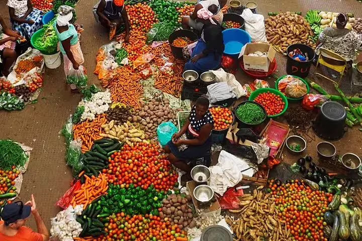 Colorful array of fresh vegetables in Santiago Island's bustling market, highlighting local flavors and cultural vibrancy.