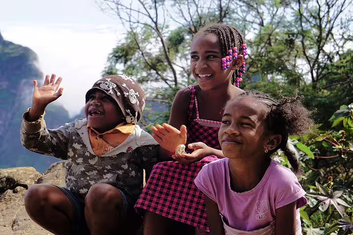 Three joyful children enjoying the scenic view during the Santo Antão island tour.