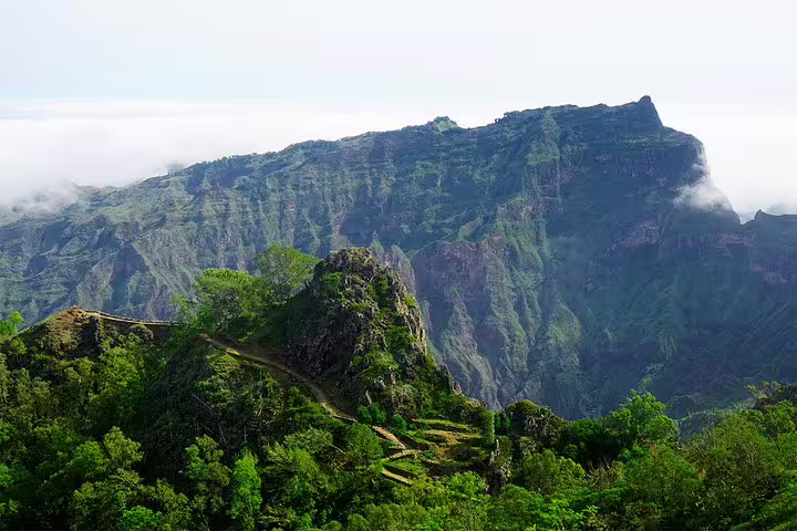 Majestic mountain landscape with terraced greenery and misty peaks in Santo Antão, Cape Verde.