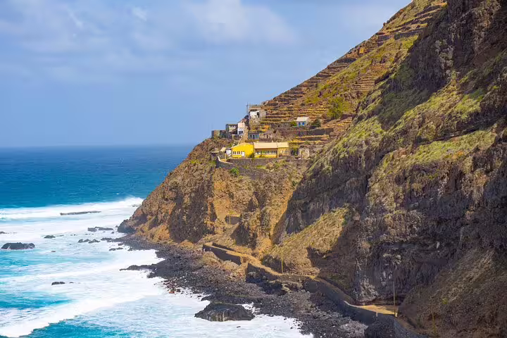 Dramatic coastal view of Ponta do Sol with rugged cliffs and ocean waves on Santo Antão hiking trail.