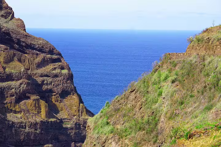 Scenic view of Atlantic Ocean framed by rugged cliffs on Santo Antão's Ponta do Sol hiking trail.