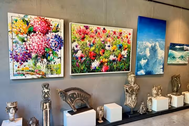Colorful art gallery in Santorini showcasing local paintings and sculptures, a cultural stop on the 5-senses tour
