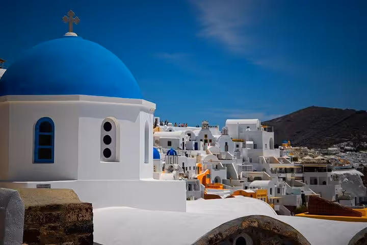 Blue-domed church and whitewashed Oia village, Santorini, on a private 3-day tour with transfers