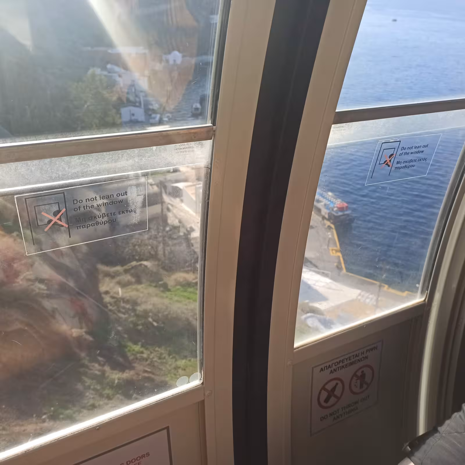 Santorini cable car ride from cruise port shore to Fira, sea views through windows on the way to Oia