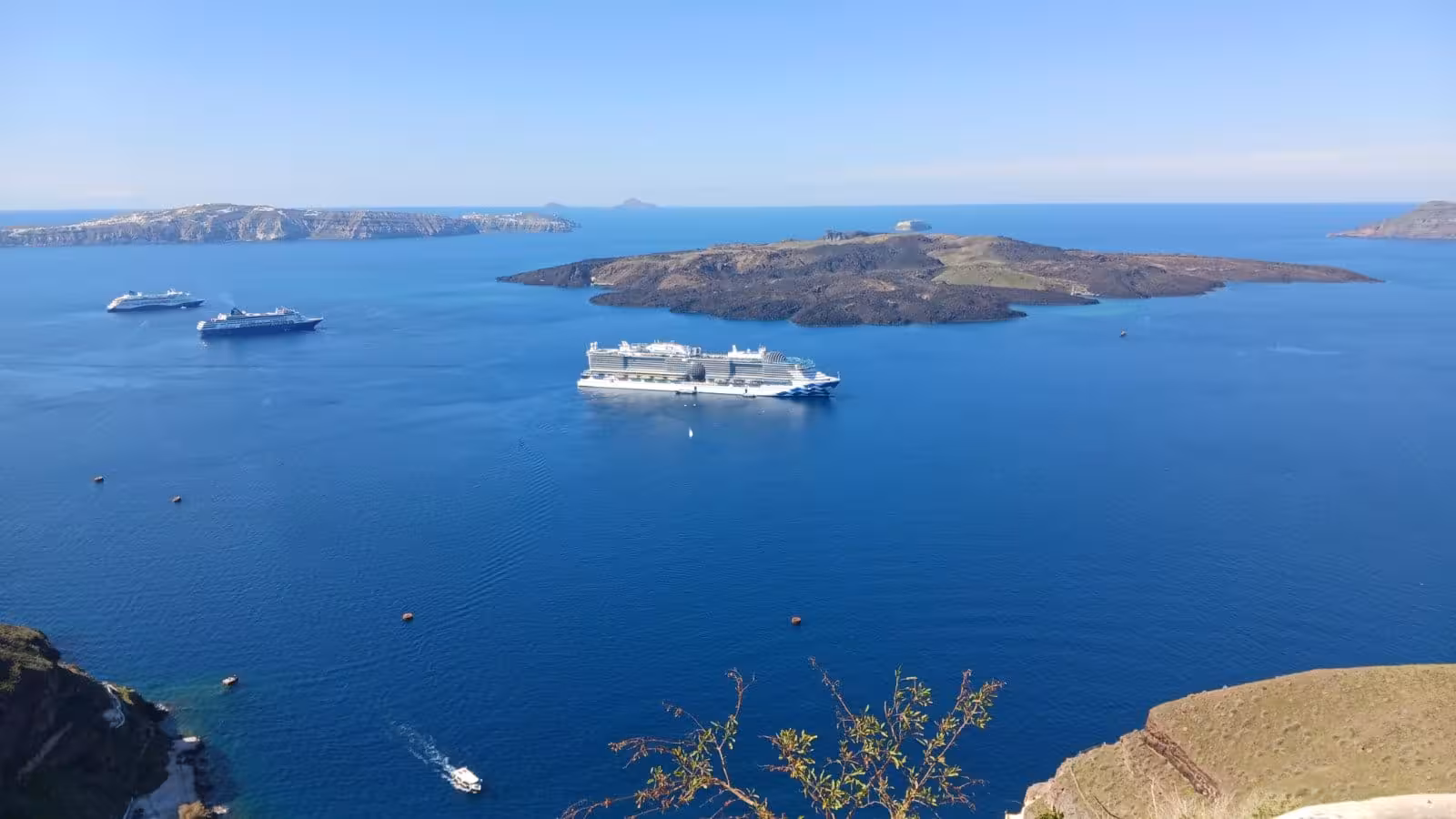 Santorini caldera with cruise ships at anchor, scenic shore excursion to Oia for cruise guests in 3 hours