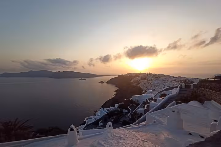 Santorini caldera sunset over Fira whitewashed rooftops and Aegean Sea, Iconic Highlights Tour view