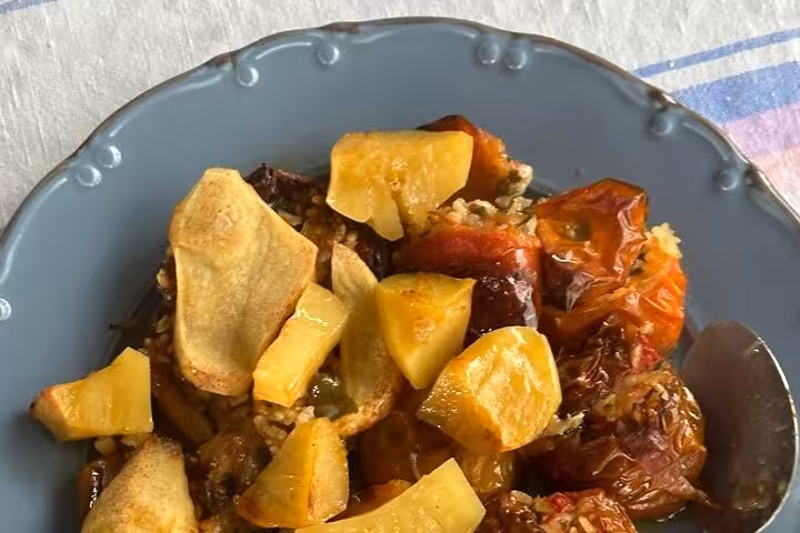 Plate of homemade Santorini farm lunch with roasted vegetables and potatoes from authentic villages tour