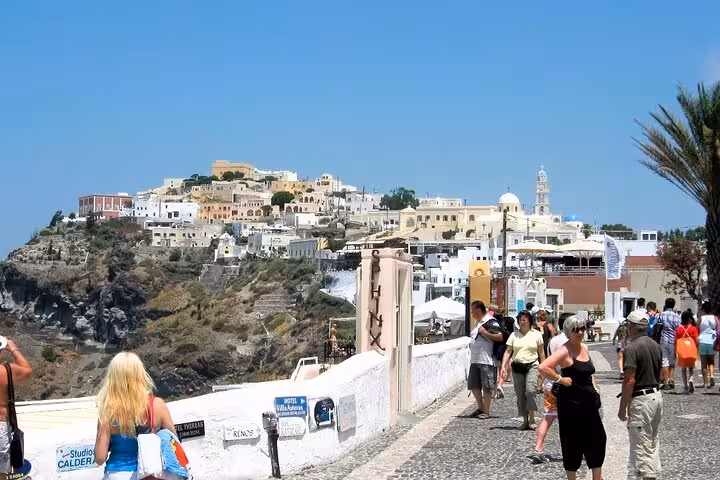 Strolling the Fira cliffside path on Santorini 5-senses tour, with caldera views and whitewashed homes