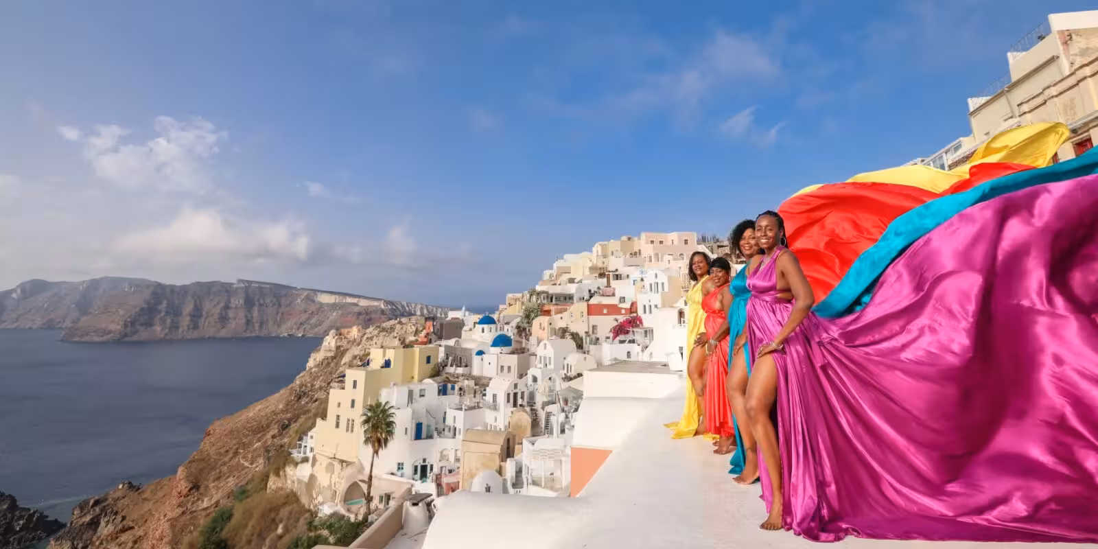 Flying dress photoshoot on Oia caldera cliffside, Santorini private tour with epic sunset-style views