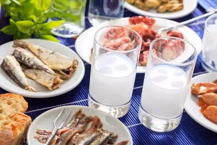 Greek meze with ouzo shots, sardines and bread, tasting Santorini flavors on the 5-senses food tour