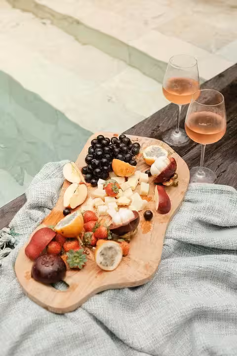 Poolside charcuterie board and rosé for a Santorini private pool day with caldera views and sunset vibes