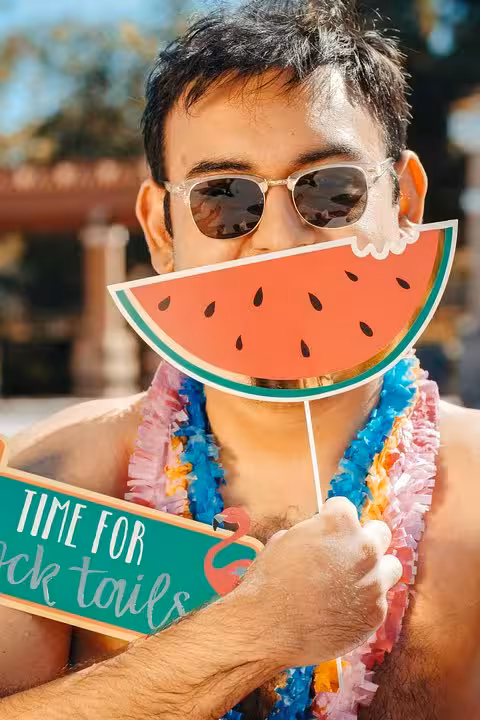 Guest at private pool holding a watermelon prop, Santorini caldera day experience with sunset views