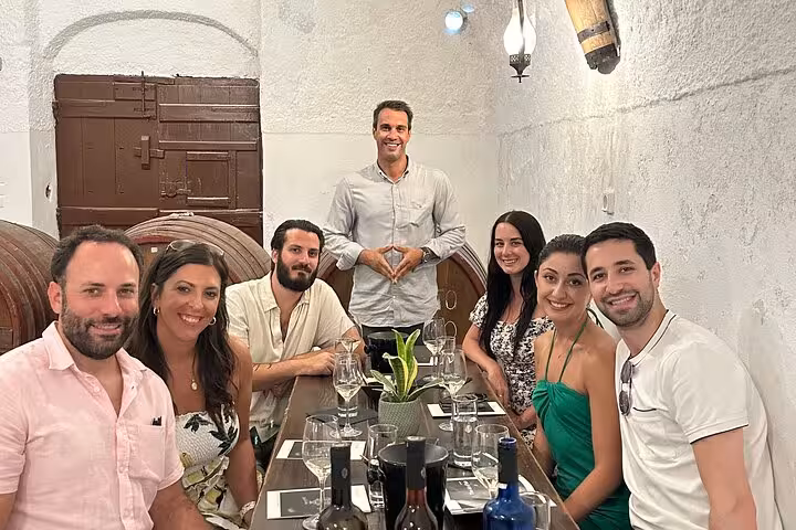 Small group wine tasting in a traditional Santorini winery cellar, part of a private tour with lunch included