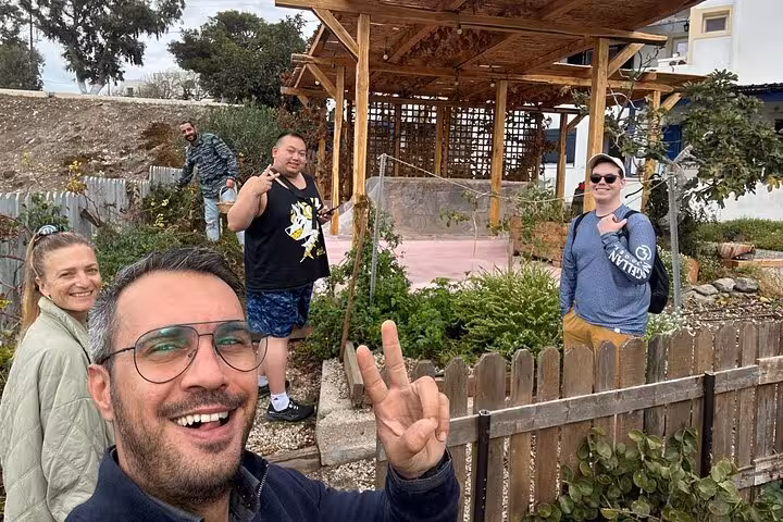 Guests posing at a Santorini traditional farmstead during authentic villages tour and local farm experience