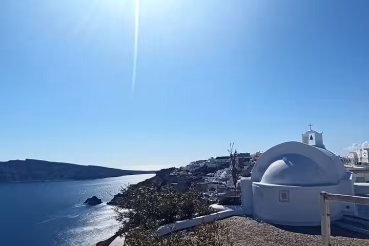 White-domed church overlooking Santorini caldera, scenic highlight on a private 3-day Santorini tour with transfer