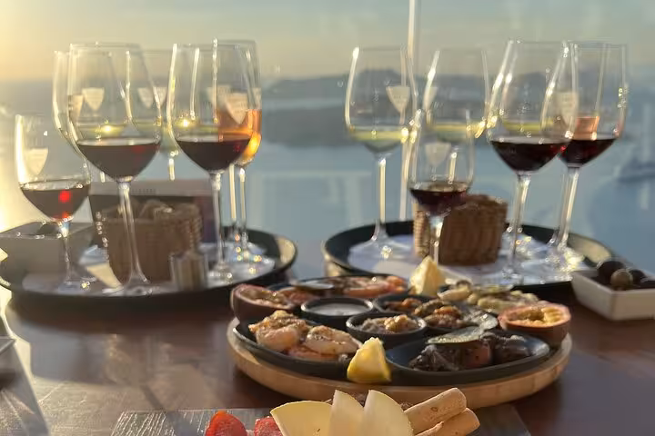 Santorini wine tasting with local meze and Vinsanto at sunset caldera view on Explore Santorini with your 5-Senses