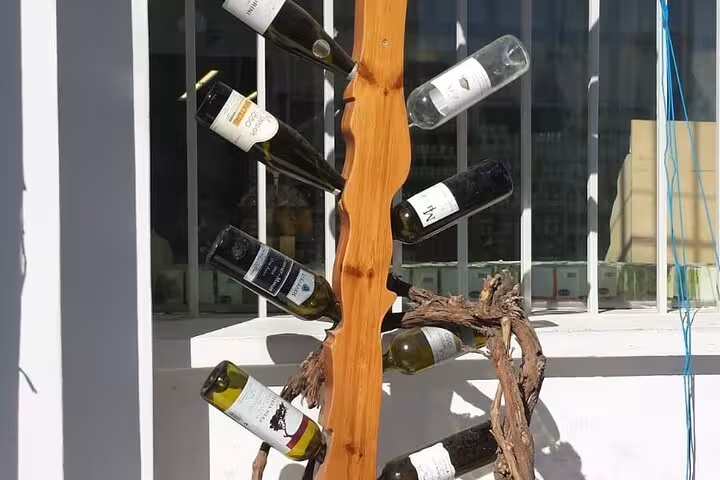 Santorini winery display with local wine bottles, ideal stop on a private 3-day Santorini tour with transfer