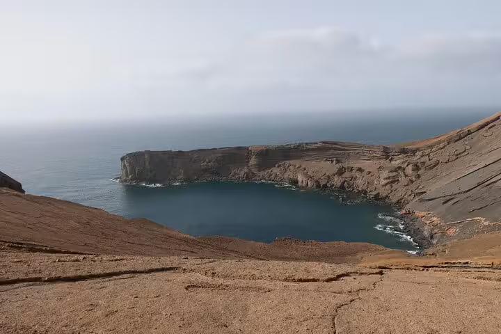 Scenic view of Carbeirinho's rugged coastline with a tranquil bay, perfect for São Nicolau hiking adventures.